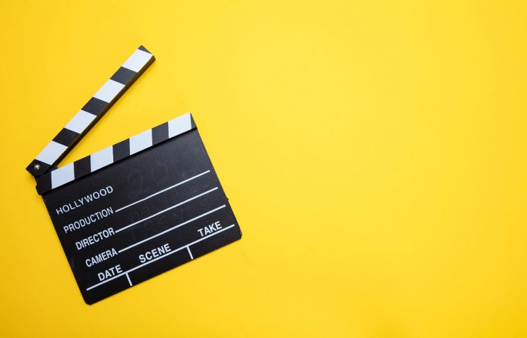 Broadcastnews movie clapperboard on yellow color background top